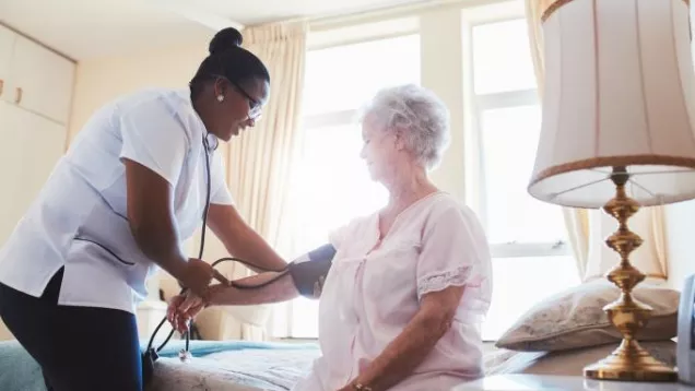 Nurse assisting elderly patient