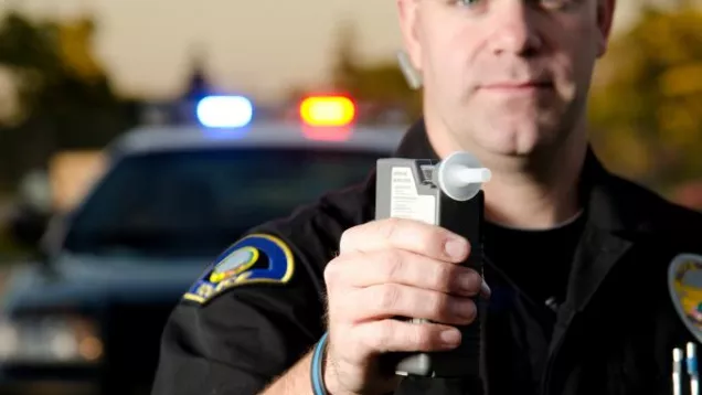 Police officer with breathalyzer